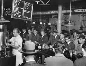 Group of men eating and drinking at Pete's Bar, Washington Market, New York City, New York, USA, Al