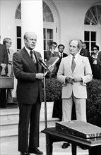 U.S. President Gerald Ford standing with Pierre Trudeau, Prime Minister of Canada, outside the