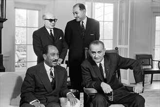 U.S. President Lyndon B. Johnson, seated with Anwar Sadat, President of the National Assembly of