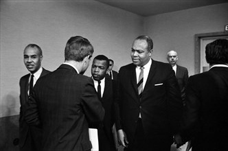 Roy Wilkins, John Lewis shaking hands with Robert F. Kennedy (with his back to the camera), and