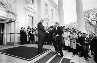 U.S. President Dwight Eisenhower, shaking hands with U.S. President-Elect John Kennedy on the steps