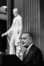 U.S. President Lyndon Johnson delivering remarks from behind podium during signing ceremony for the