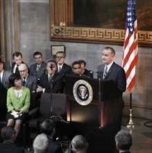 U.S. President Lyndon Johnson delivering remarks from behind podium during signing ceremony for the