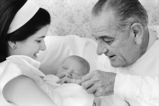 U.S. President Lyndon B. Johnson visiting daughter Luci Johnson Nugent and first grandchild,