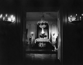 Late U.S. President John Kennedy’s flag-draped casket, members of honor guard standing watch, East