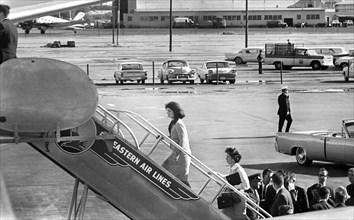 U.S. First Lady Jacqueline Kennedy and her secretary, Mary Gallagher, board Air Force One following