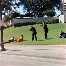 Witnesses laying down in grass immediately following assassination of U.S. President John Kennedy.