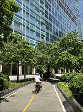 Cyclist on bicycle path alongside Goldman Sachs Global Headquarters, 200 West Street, New York