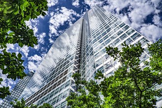 200 West Street, low angle view, building exterior surrounded by trees against clouds and blue sky,