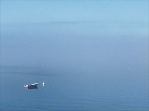 Moored rowboat at sea