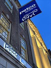 Petco store, building exterior, low angle view at dusk, New York City, New York, USA