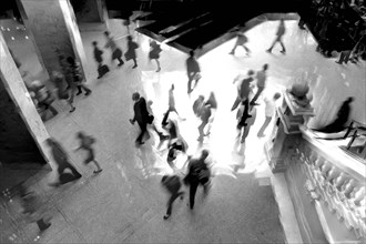 High angle view of office workers walking through office building lobby