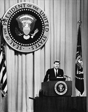 U.S. President John F. Kennedy at lectern during press conference, U.S. State Department