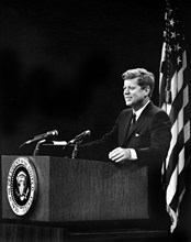 U.S. President John F. Kennedy at lectern during press conference, U.S. State Department