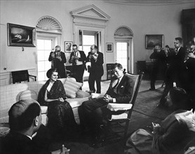 U.S. President John F. Kennedy (in rocking chair) meeting with Indira Gandhi, daughter of Prime