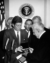 U.S. President John F. Kennedy presenting Congressional Gold Medal to American poet Robert Frost,