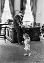 U.S. President John F. Kennedy and his son John F. Kennedy, Jr., in Oval Office, White House,