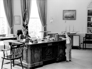 U.S. President John F. Kennedy and his daughter Caroline in Oval Office, White House, Washington, D