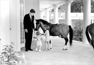 U.S. President John Kennedy and his children, John Kennedy, Jr., and Caroline Kennedy, standing