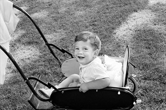 John Kennedy, Jr., sitting in carriage on South Lawn, Washington, D.C., USA, Cecil Stoughton, White