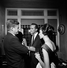 U.S. President John F. Kennedy talking with singer, Harry Belafonte, and Julie Robinson Belafonte