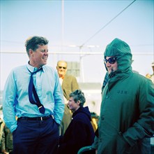 U.S. President John F. Kennedy (wearing a PT-109 pin on his tie) laughing with Press Secretary