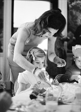 U.S. First Lady Jacqueline Kennedy lighting birthday candle for her daughter, Caroline Kennedy,