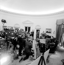 Cameramen film U.S. President John F. Kennedy delivering radio and television address to the nation