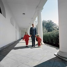 U.S. President John F. Kennedy walking with his children, Caroline Kennedy and John F. Kennedy, Jr