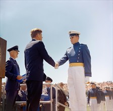 U.S. President John F. Kennedy (left) shaking hands with unidentified cadet during commencement