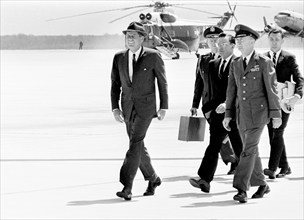 U.S. President John F. Kennedy walking to board flight to attend centennial ceremonies at Boston