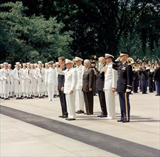 U.S. President John F. Kennedy and others standing at attention at Tomb of the Unknown Soldier