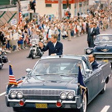 U.S. President John F. Kennedy (standing in first car) with Governor of California, Edmund G. "Pat"