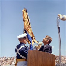 U.S. President John F. Kennedy receiving U.S. Air Force Academy ceremonial flag from unidentified