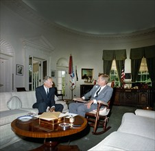 U.S. President John F. Kennedy (in rocking chair) meeting with newly-appointed U.S. Ambassador to