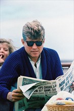 U.S. President John F. Kennedy reading newspaper with  his daughter, Caroline Kennedy in