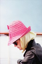 Head and shoulders profile portrait of U.S. First Lady Jacqueline Kennedy wearing pink hat and