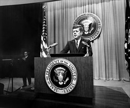 U.S. President John F. Kennedy delivering remarks during press conference, State Department