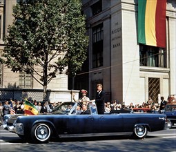 U.S. President John F. Kennedy and Emperor of Ethiopia, Haile Selassie I, waving to crowd along