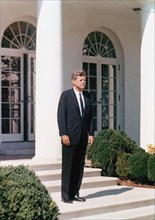 U.S. President John F. Kennedy standing on steps of Rose Garden, White House, Washington, D.C.,