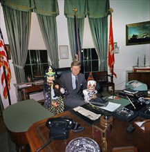 U.S. President John F. Kennedy visiting with his children, Caroline Kennedy (left, holding cat) and