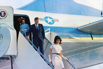 U.S. President John F. Kennedy and U.S. First Lady Jacqueline Kennedy exit Air Force One upon their