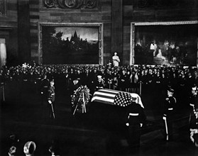 U.S. President Lyndon Johnson standing with bowed head at U.S. President John F. Kennedy's