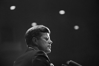 Head and shoulders portrait of U.S. President John F. Kennedy delivering remarks at dinner in honor