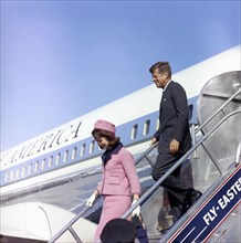 U.S. President John F. Kennedy and U.S. First Lady Jacqueline Kennedy descending stairs from Air