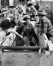 Gig Young (center on horse), on-set of the western film, "Arena", Loew's Inc., 1953