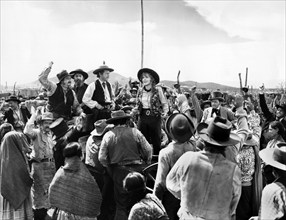 Regis Toomey (standing left of center), Jean Arthur (standing center), on-set of the western film,