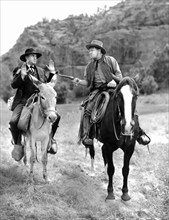 Wallace Beery (right), on-set of the western film, "The Bad Man Of Brimstone", Loew's Inc., 1937