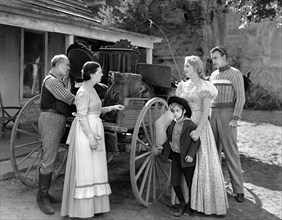 Scotty Beckett (small boy), Virginia Bruce (2nd right), Dennis O'Keefe (right), on-set of the