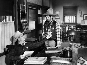 Gene Autry, Pat Buttram, on-set of the western film, "Beyond The Purple Hills", Columbia Pictures,